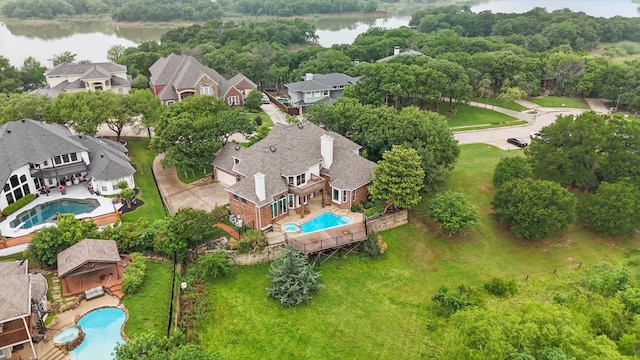 birds eye view of property with a residential view and a water view