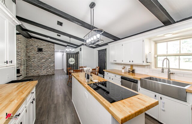 504 Mockingbird Ln, Logansport, LA 71049 - kitchen featuring a center island, butcher block counters, dishwasher, lofted ceiling with beams, and a sink
