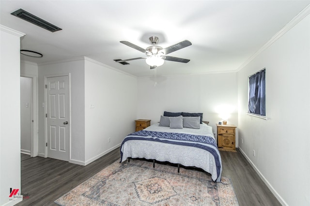 504 Mockingbird Ln, Logansport, LA 71049 - bedroom with visible vents, ornamental molding, and dark wood-style flooring