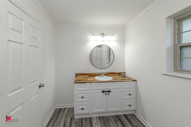 504 Mockingbird Ln, Logansport, LA 71049 - bathroom with vanity, crown molding, wood finished floors, and baseboards