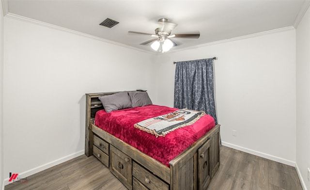 504 Mockingbird Ln, Logansport, LA 71049 - bedroom featuring baseboards, visible vents, dark wood finished floors, ceiling fan, and crown molding