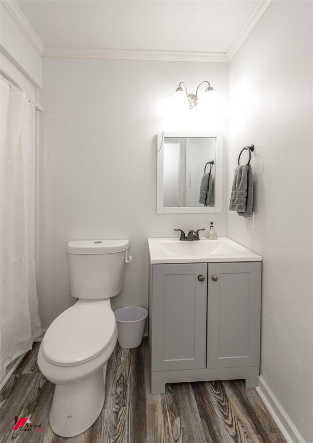 504 Mockingbird Ln, Logansport, LA 71049 - full bathroom featuring toilet, wood finished floors, and ornamental molding