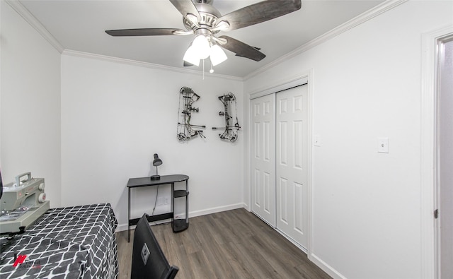 504 Mockingbird Ln, Logansport, LA 71049 - bedroom with baseboards, dark wood-style flooring, ceiling fan, a closet, and crown molding