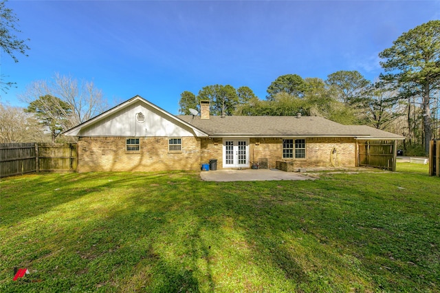 504 Mockingbird Ln, Logansport, LA 71049 - back of house with french doors, a yard, a chimney, and fence