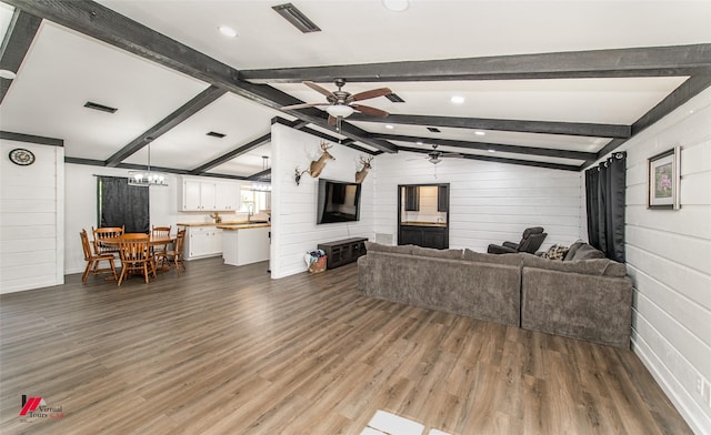 504 Mockingbird Ln, Logansport, LA 71049 - living area with visible vents, vaulted ceiling with beams, and dark wood-style flooring