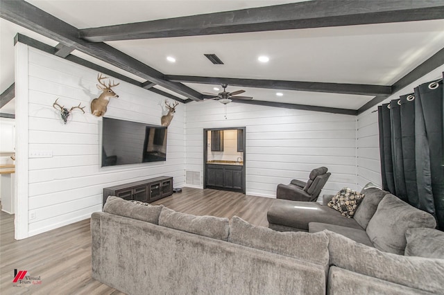 504 Mockingbird Ln, Logansport, LA 71049 - living area featuring wooden walls, visible vents, vaulted ceiling with beams, wood finished floors, and a ceiling fan
