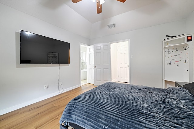 bedroom featuring visible vents, baseboards, ensuite bathroom, wood finished floors, and a ceiling fan