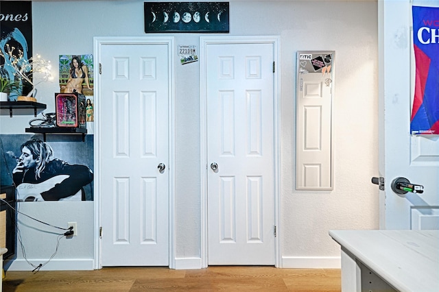 interior space featuring baseboards and light wood-style flooring