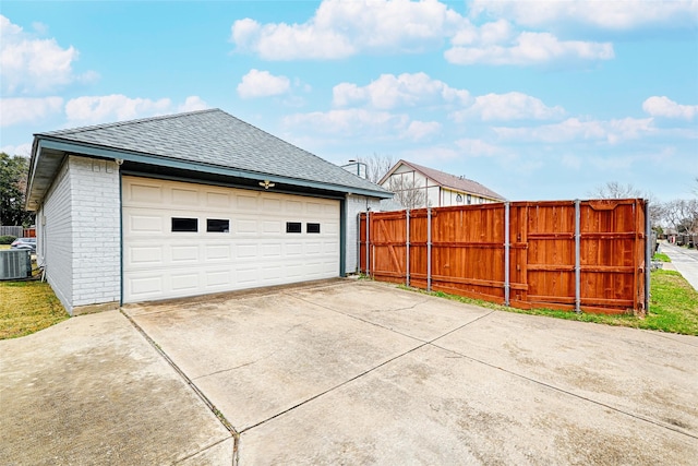 detached garage with fence and central AC