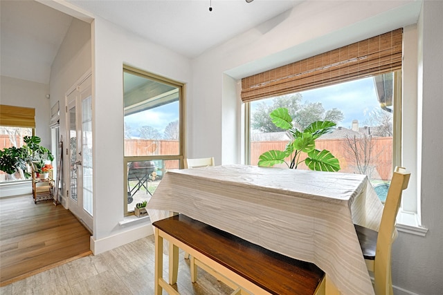 dining room featuring baseboards and light wood finished floors