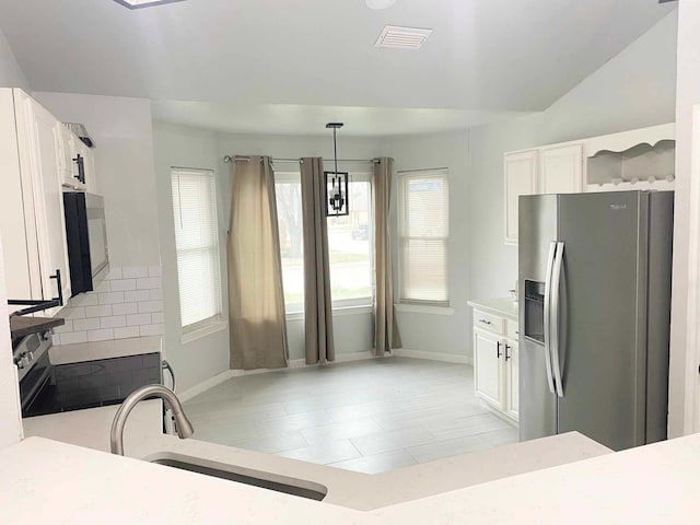 kitchen featuring white cabinets, visible vents, appliances with stainless steel finishes, and a sink