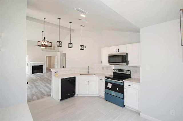 kitchen featuring stainless steel microwave, range with electric cooktop, visible vents, black dishwasher, and a sink