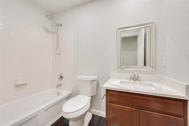 full bathroom with toilet, wood finished floors,  shower combination, baseboards, and vanity