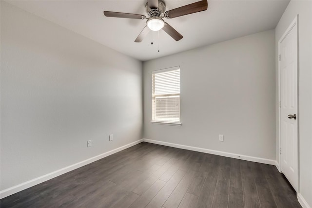 unfurnished bedroom with baseboards, dark wood-style floors, and a ceiling fan