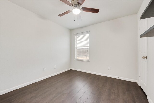 spare room with baseboards, wood finished floors, and a ceiling fan