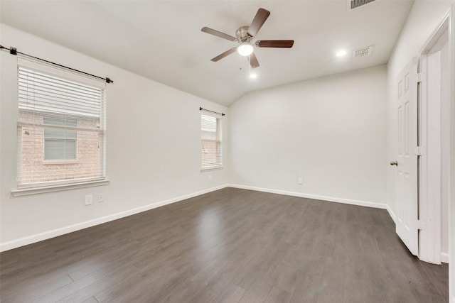 spare room featuring visible vents, ceiling fan, dark wood-type flooring, and baseboards