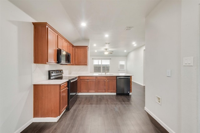 kitchen with brown cabinetry, visible vents, appliances with stainless steel finishes, and a peninsula