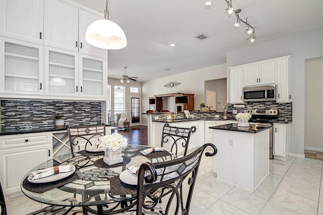 kitchen featuring dark countertops, visible vents, appliances with stainless steel finishes, and ceiling fan