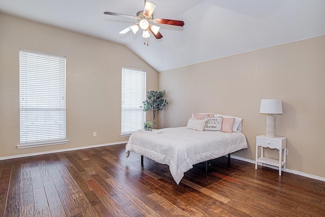 bedroom with baseboards, hardwood / wood-style floors, a ceiling fan, and vaulted ceiling
