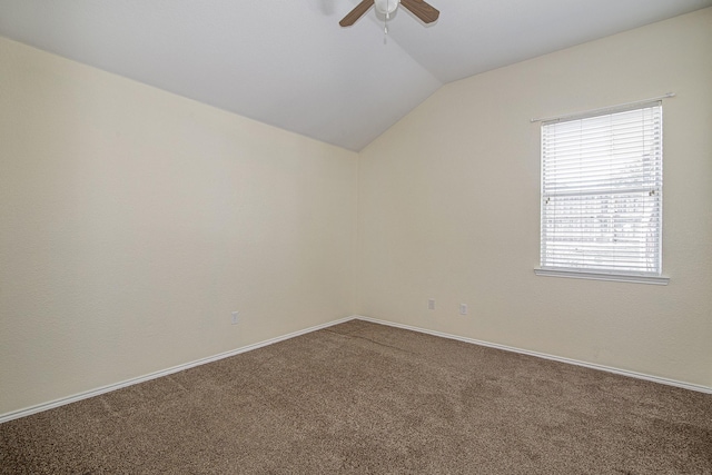 unfurnished room with baseboards, lofted ceiling, carpet floors, and ceiling fan