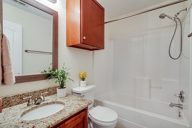 bathroom featuring vanity, visible vents,  shower combination, toilet, and a textured wall