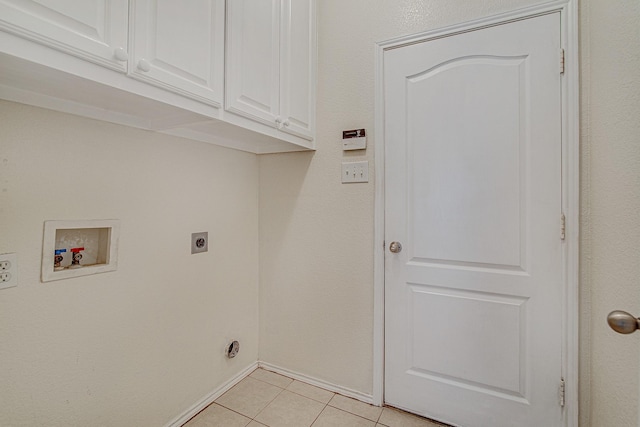 clothes washing area featuring baseboards, hookup for a washing machine, light tile patterned flooring, cabinet space, and electric dryer hookup