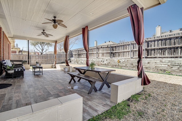 view of patio / terrace featuring ceiling fan, outdoor dining area, and a fenced backyard