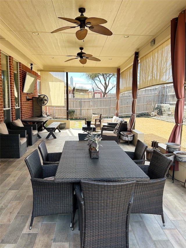 view of patio / terrace with outdoor lounge area, fence, and ceiling fan