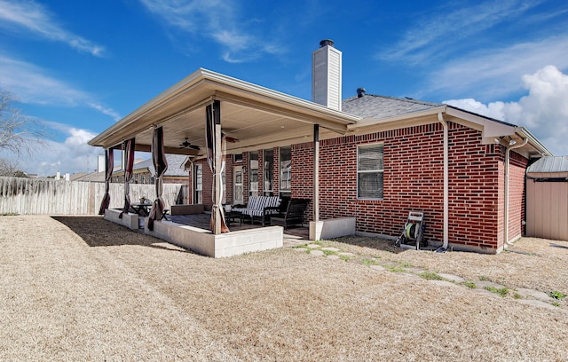 view of patio / terrace featuring ceiling fan and fence