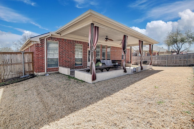 exterior space with a ceiling fan and a fenced backyard