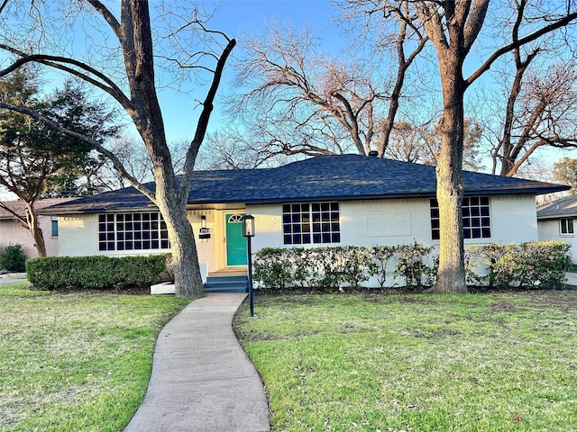 single story home featuring brick siding and a front lawn