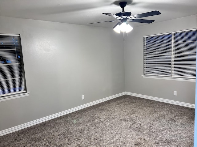 spare room featuring carpet flooring, a ceiling fan, and baseboards