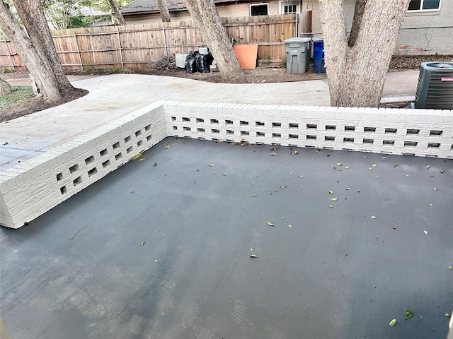 exterior details with central AC unit and fence