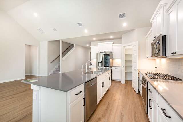 kitchen featuring a sink, visible vents, light wood-type flooring, and appliances with stainless steel finishes