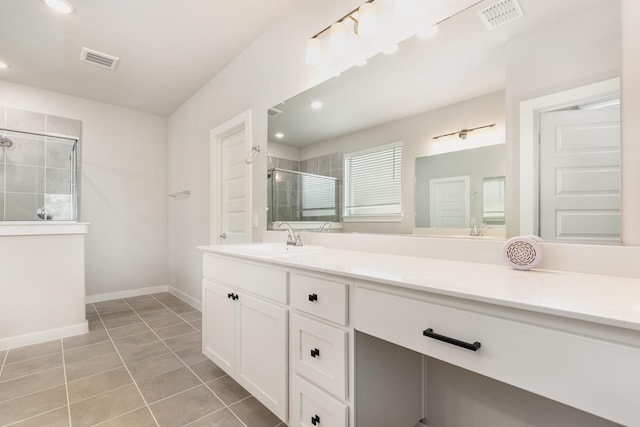 full bathroom featuring visible vents, vanity, a shower stall, and tile patterned flooring