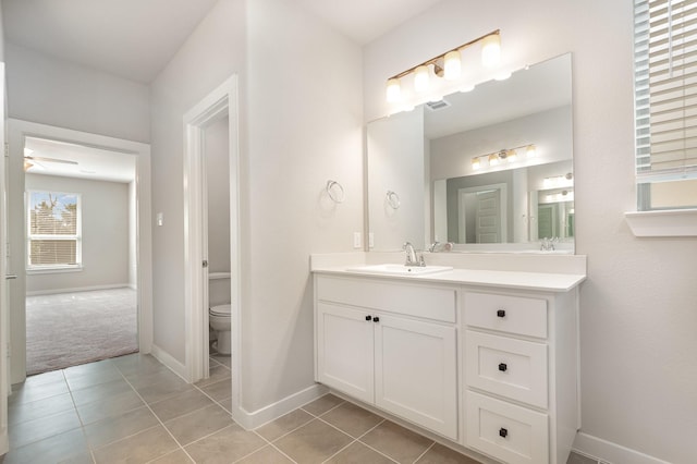 full bath featuring vanity, visible vents, baseboards, tile patterned floors, and toilet