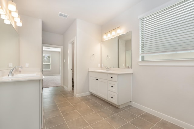 bathroom featuring tile patterned flooring, visible vents, and a sink