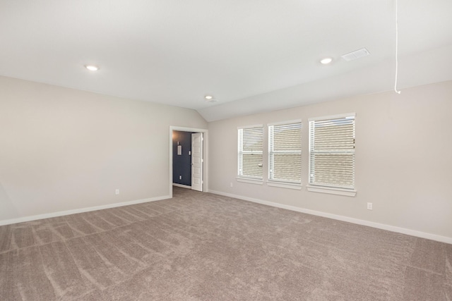 spare room featuring recessed lighting, baseboards, carpet flooring, and vaulted ceiling