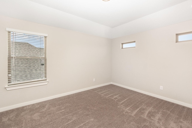 empty room featuring baseboards and carpet floors