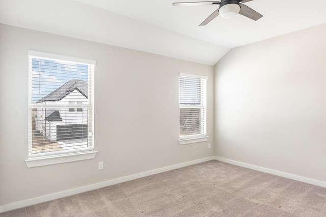 spare room featuring a healthy amount of sunlight, baseboards, and light carpet