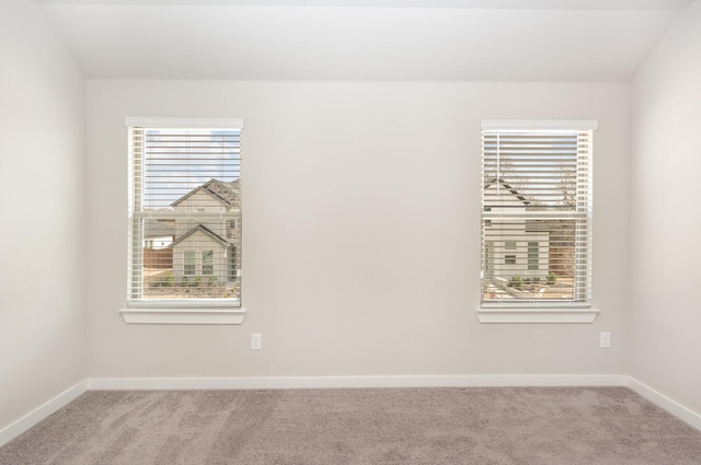 carpeted spare room with baseboards