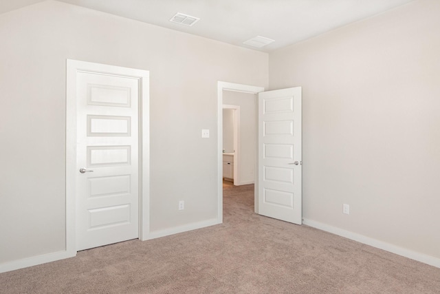 carpeted empty room with visible vents and baseboards