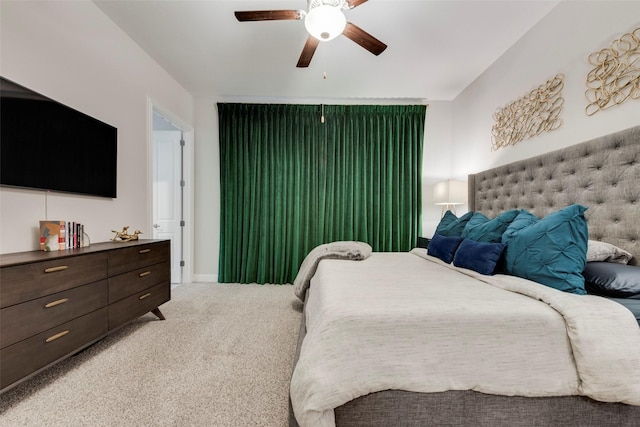 bedroom featuring light colored carpet and ceiling fan