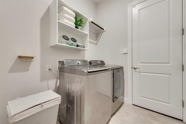 laundry room with light tile patterned floors, laundry area, and washing machine and dryer