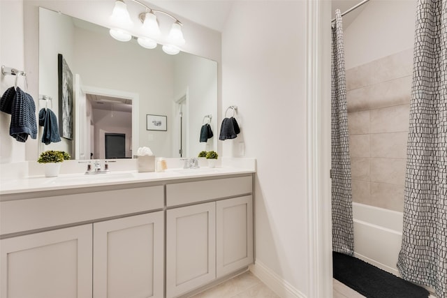 full bath featuring double vanity, shower / bathtub combination with curtain, tile patterned floors, and a sink