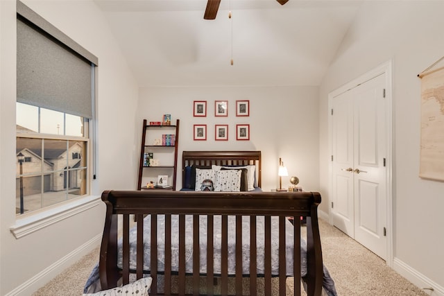 carpeted bedroom featuring baseboards, lofted ceiling, and ceiling fan