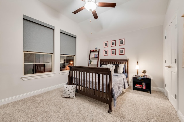 carpeted bedroom featuring baseboards, ceiling fan, and vaulted ceiling