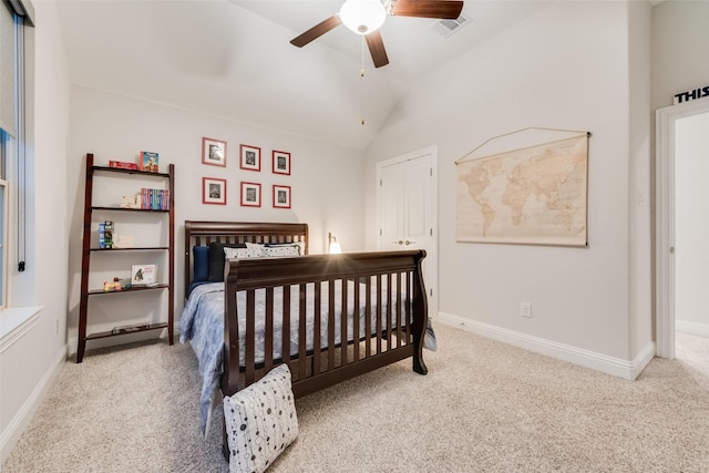 carpeted bedroom with vaulted ceiling, a ceiling fan, baseboards, and visible vents