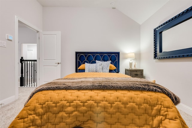 bedroom with carpet flooring, baseboards, and vaulted ceiling