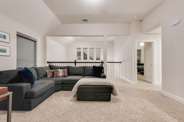 living room with lofted ceiling, baseboards, visible vents, and carpet floors